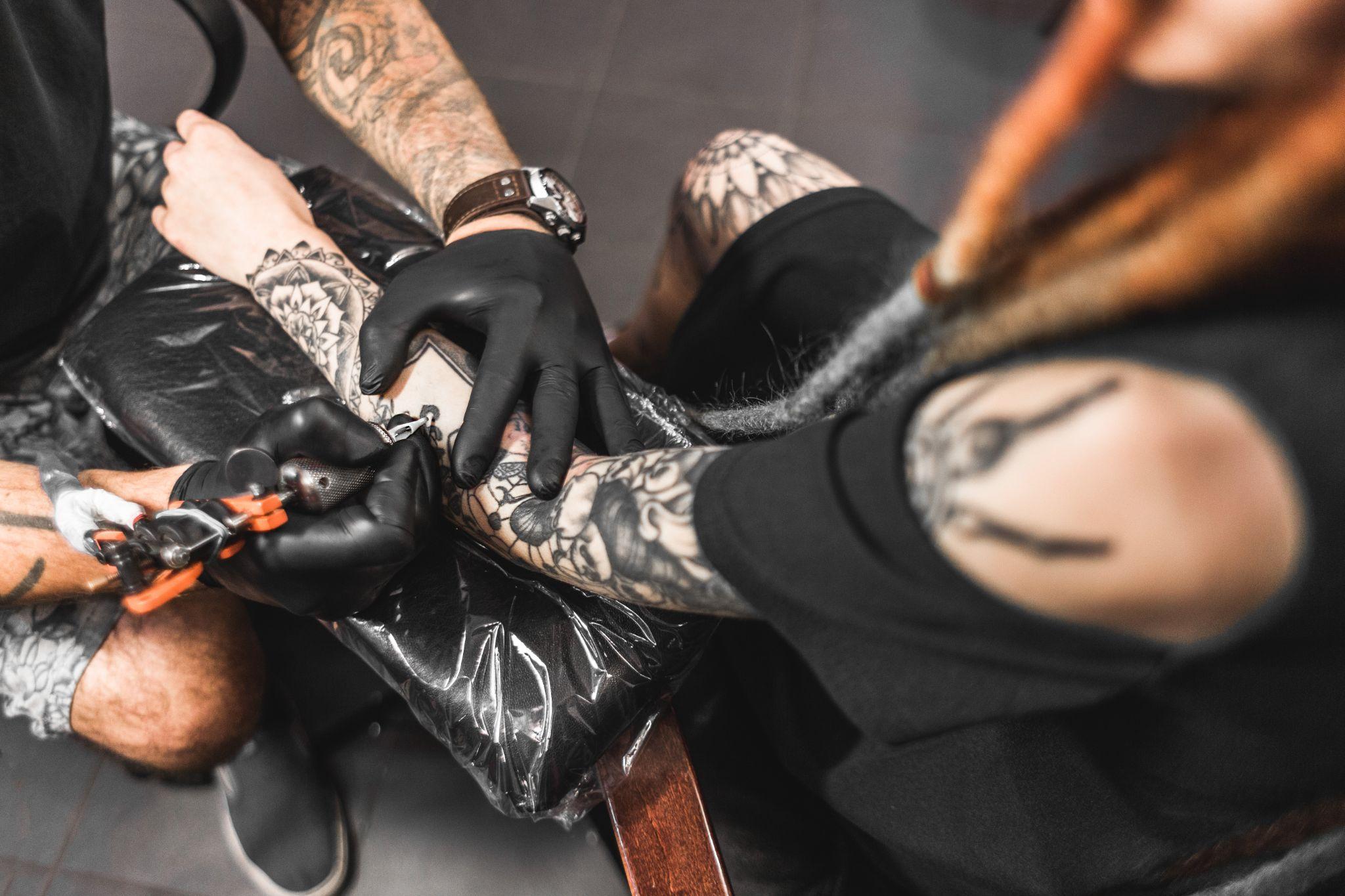 Woman getting a new tattoo at a tattoo parlor
