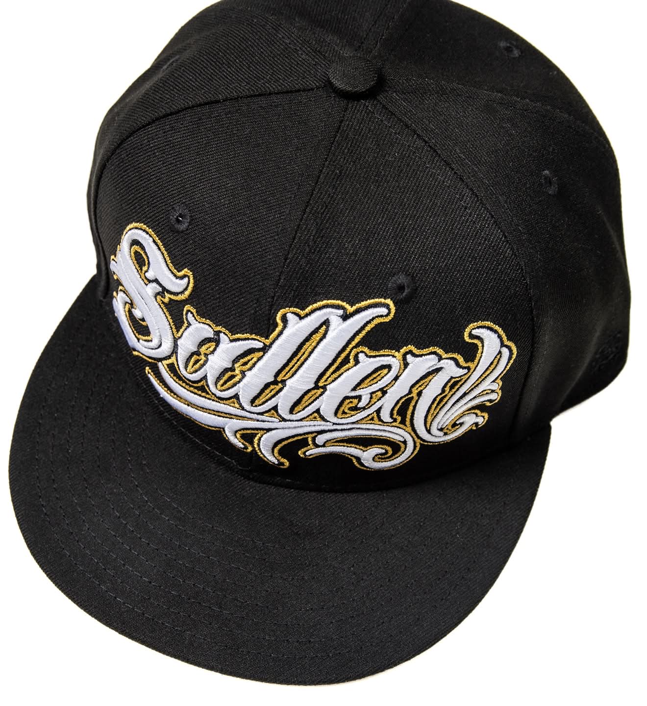 Black cap with gold and white text on a white background