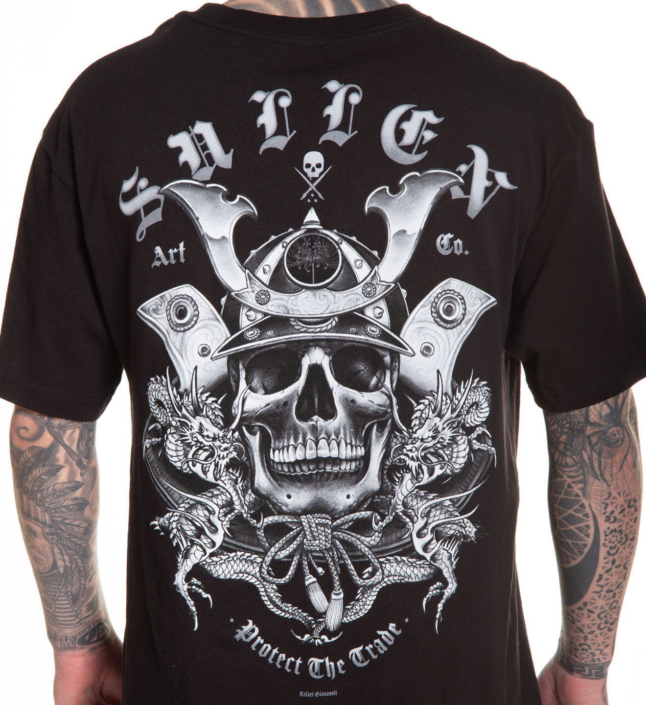 Black t-shirt with a detailed skull and crossbones design on the back, worn by a person with tattoos.