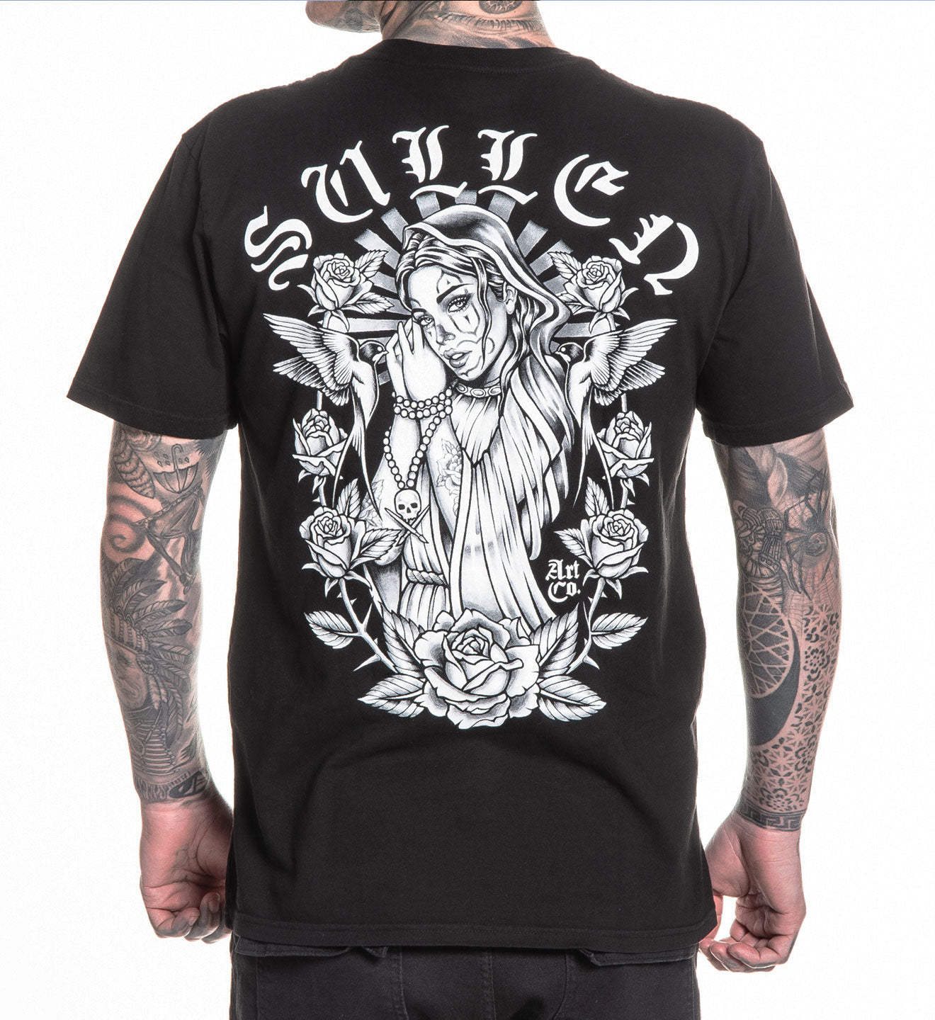 Black t-shirt with a detailed graphic design on the back, worn by a person with tattoos.