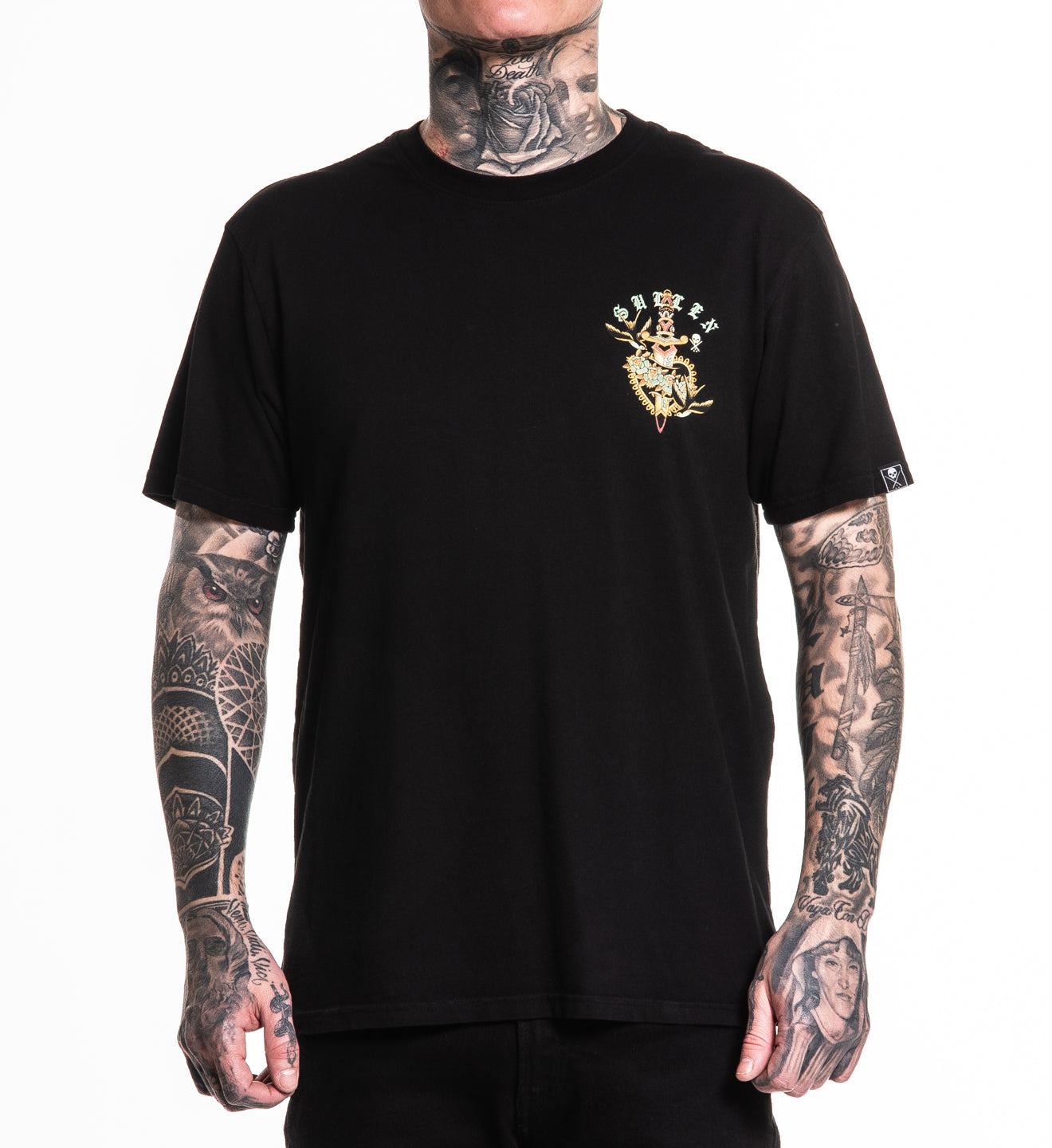 Person wearing a black t-shirt with a gold logo on a white background