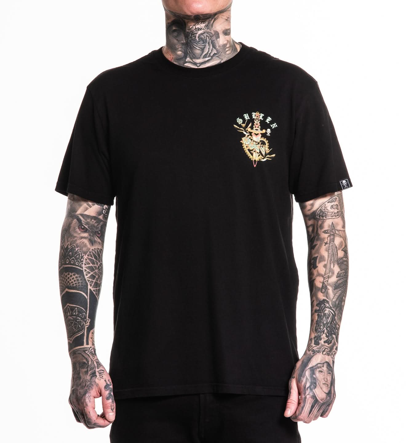 Person wearing a black t-shirt with a gold logo on a white background