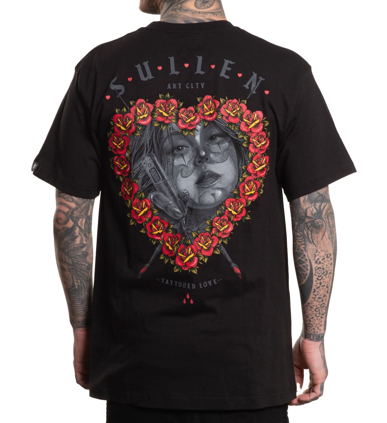 Black t-shirt with a graphic design on the back, featuring a heart shape with roses and a face, worn by a person.