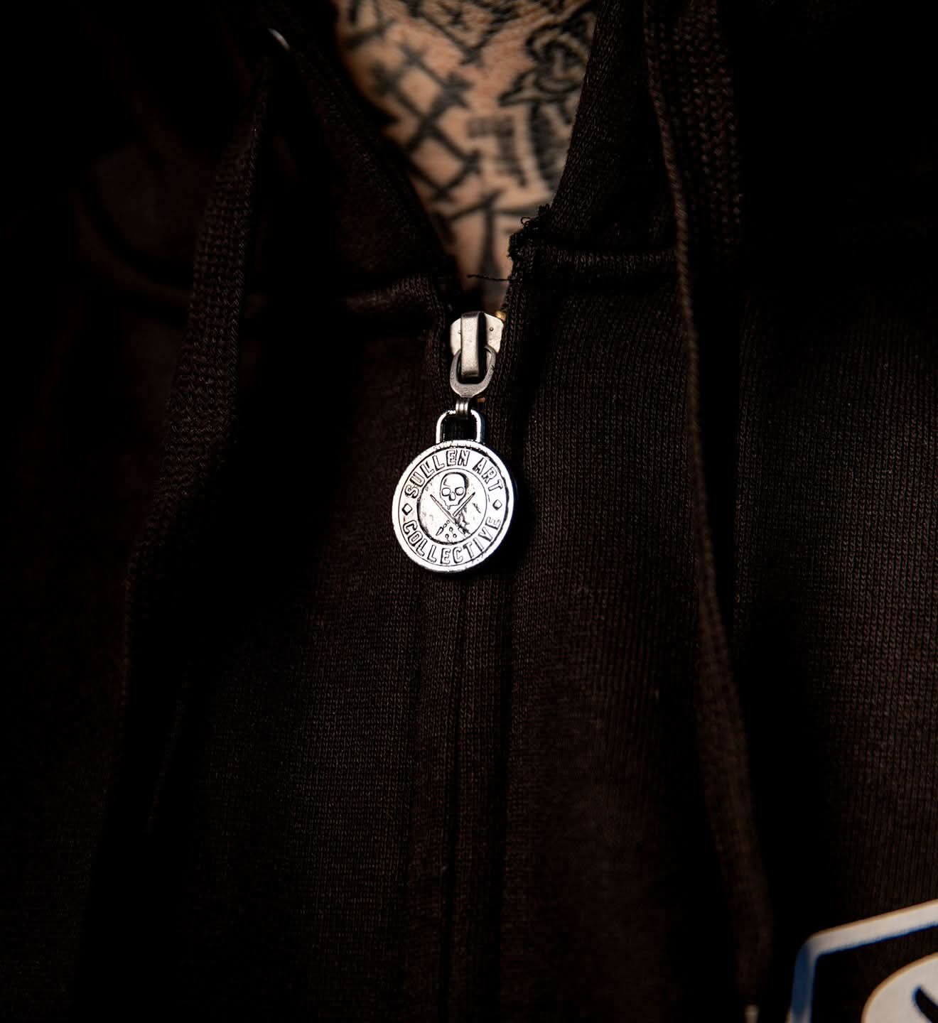 Close-up of a silver pendant with a dark background