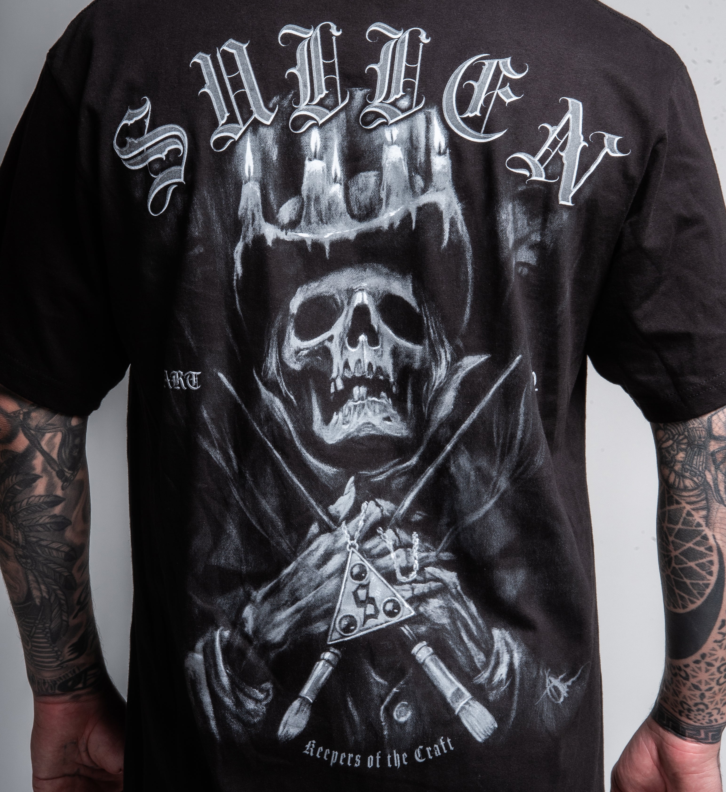 Black t-shirt with a graphic design of a skeleton holding a sword and 'Sullva' text on the back.