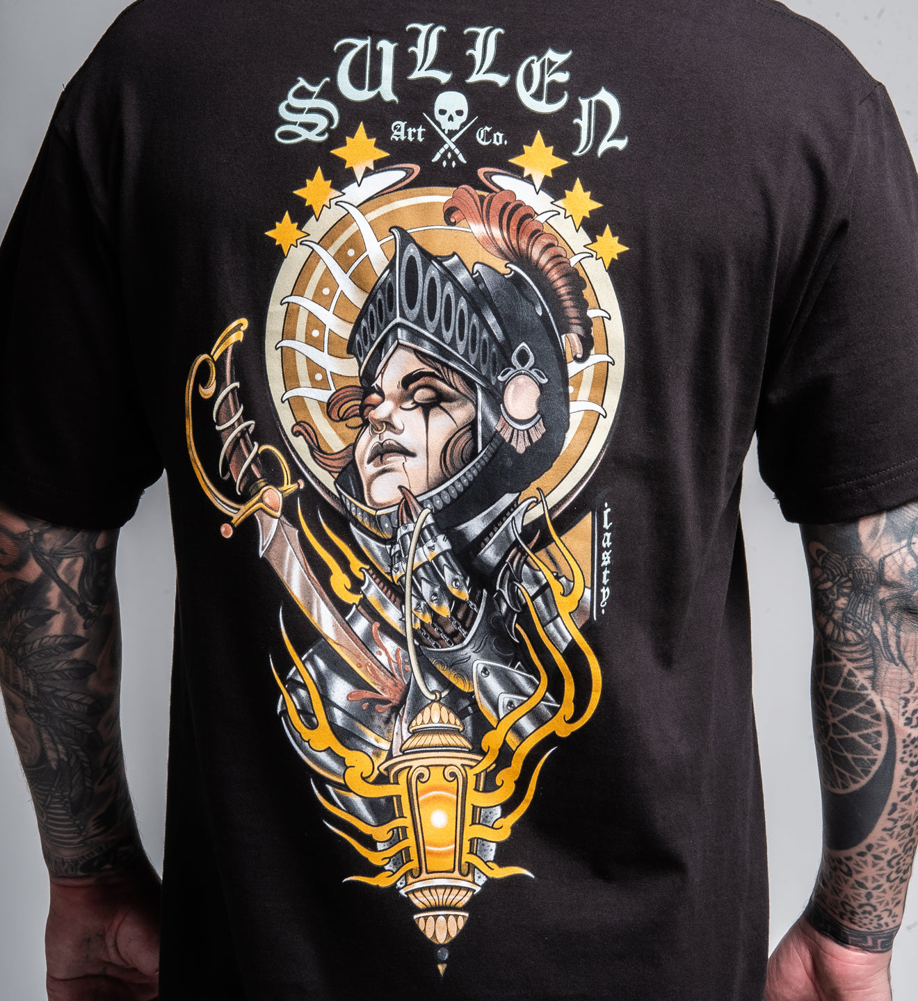 Black t-shirt with a detailed graphic design and 'Sullen' branding on the back.