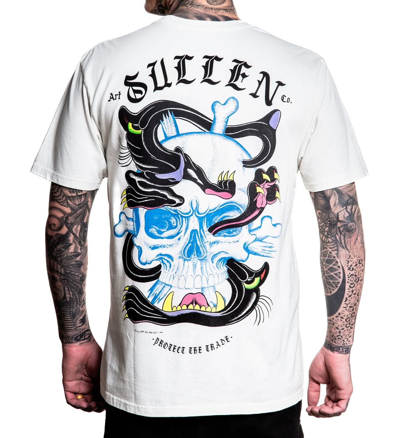 Person wearing a white t-shirt with a colorful skull design and 'Sullen' branding on the back.
