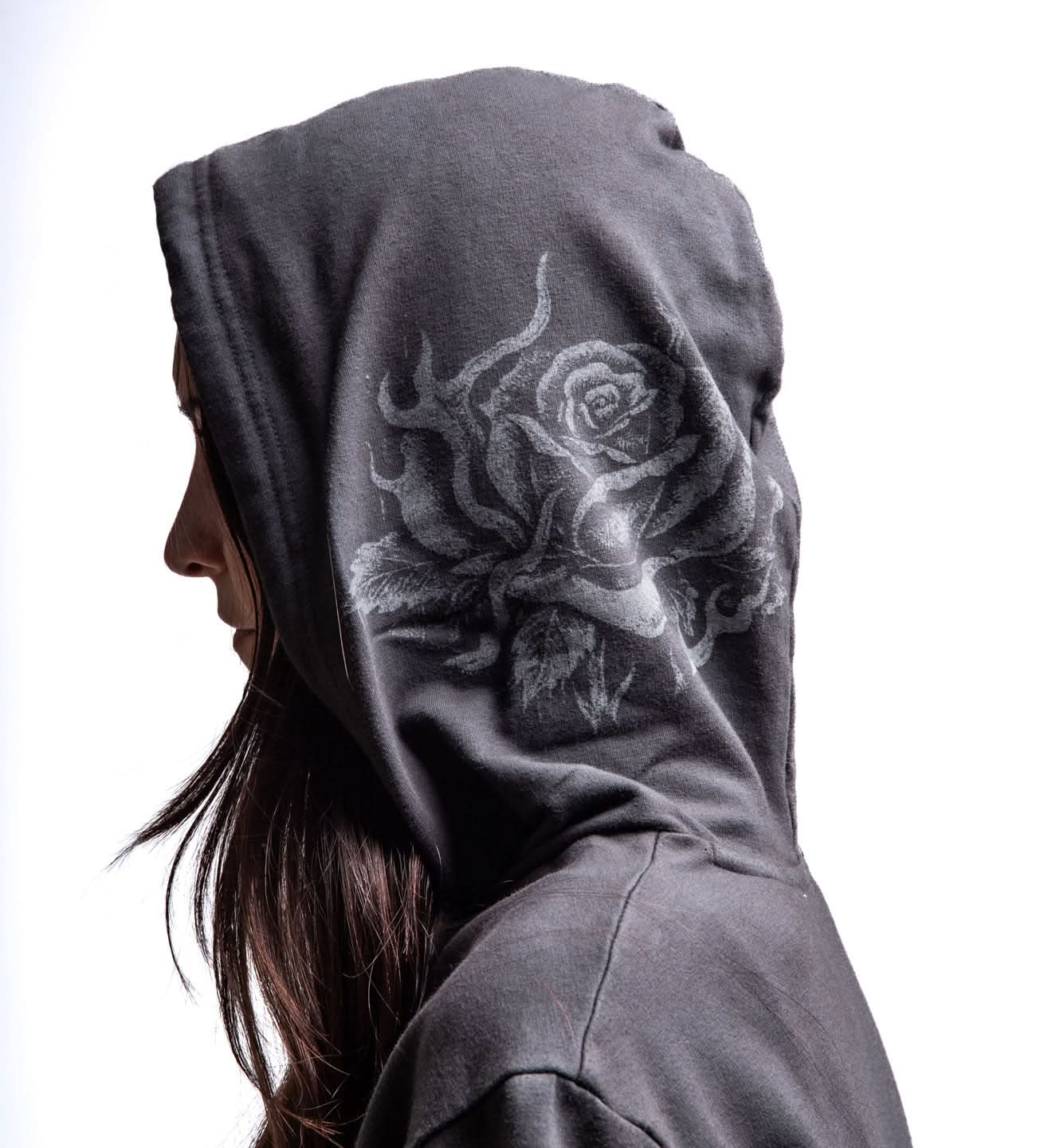 Person wearing a dark gray hoodie with a white graphic design on a light gray background