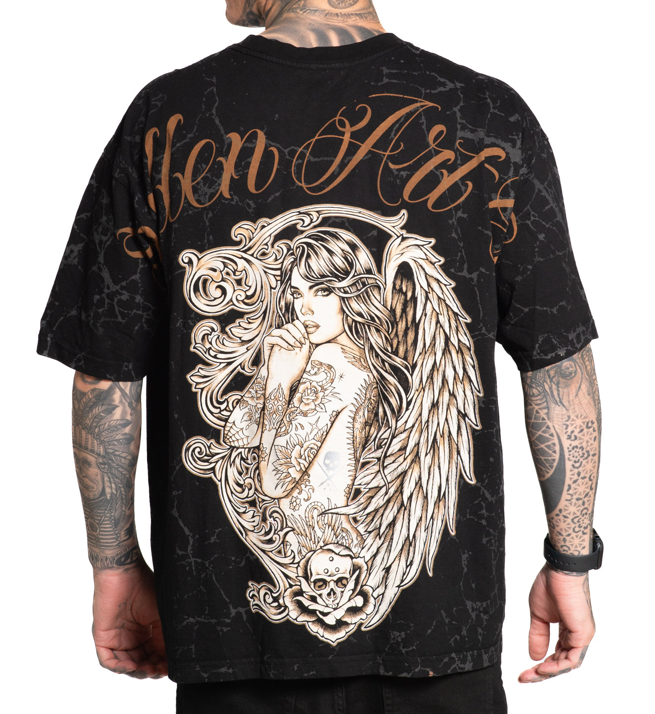 Black t-shirt with angel design and text on the back, worn by a person.