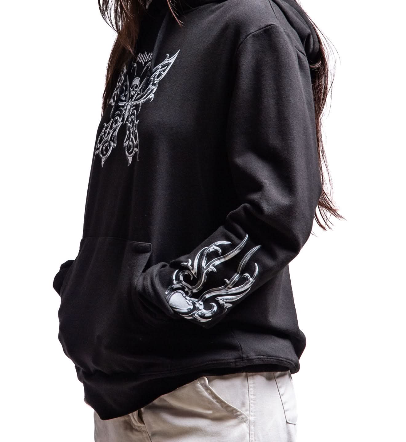 Black hoodie with silver tribal designs on sleeves and chest, worn by a person.