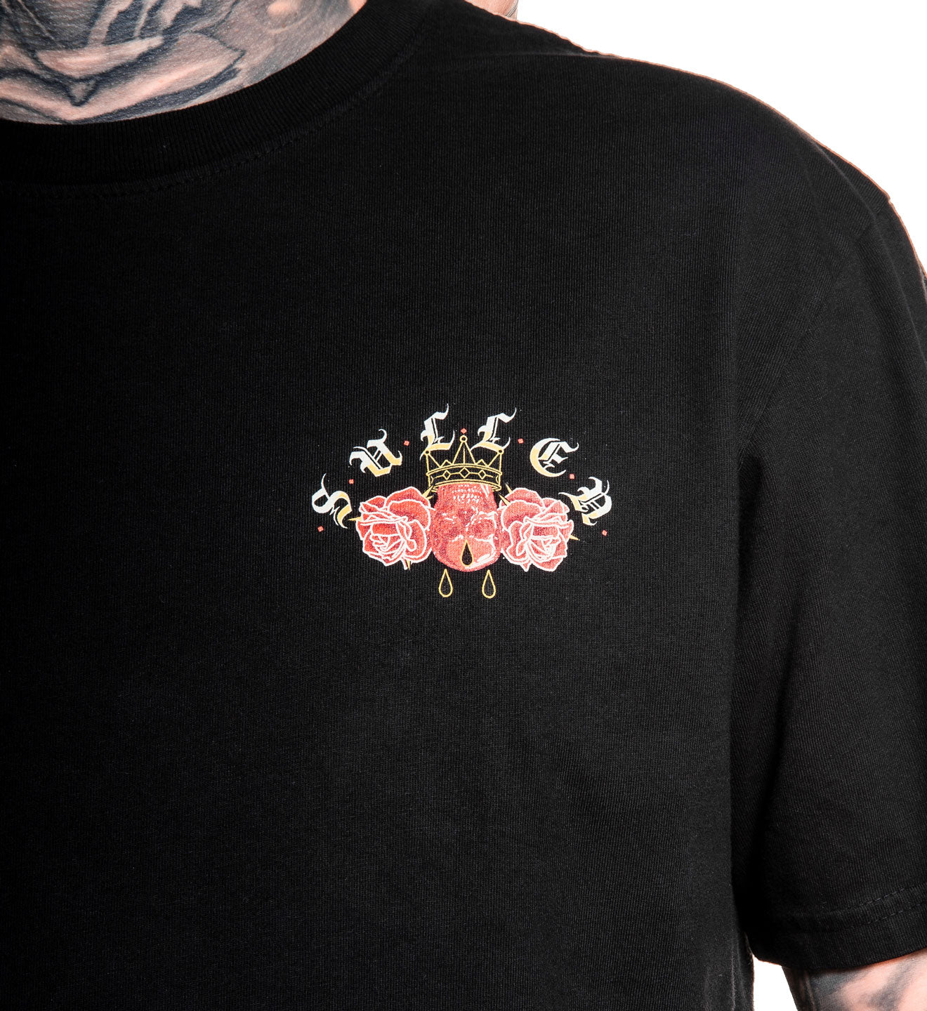 Black t-shirt with a decorative design on the chest featuring roses and a crown.