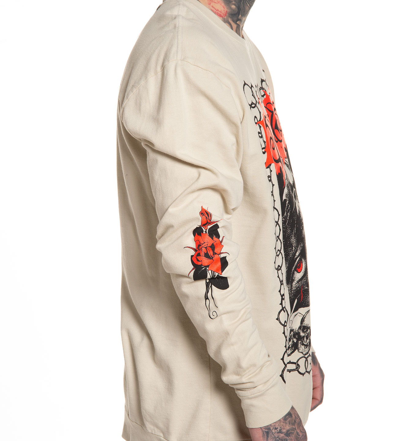 Beige sweatshirt with black and red floral designs on sleeves against a white background
