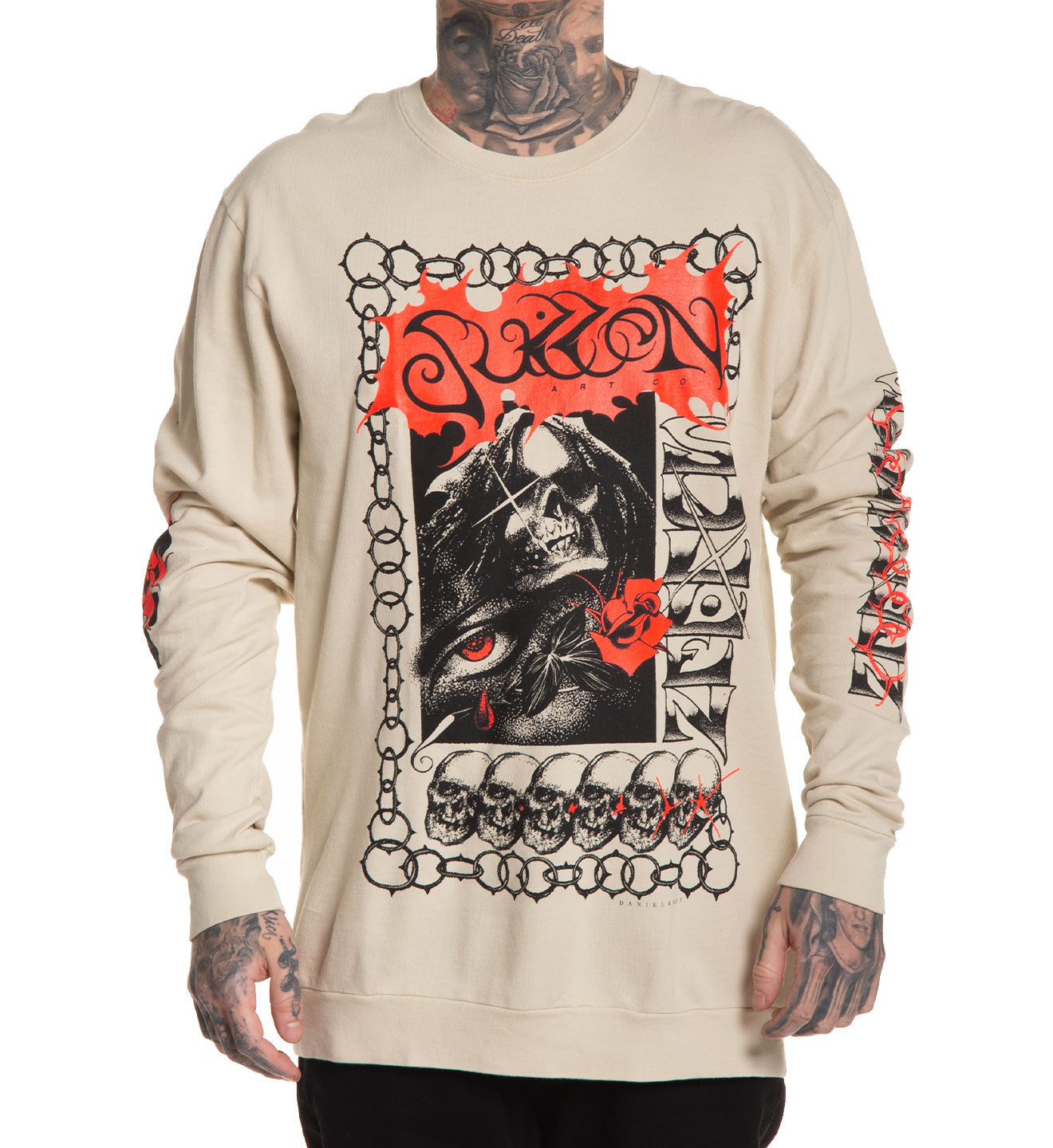 Beige long-sleeve shirt with graphic design featuring a skull and red text on a white background