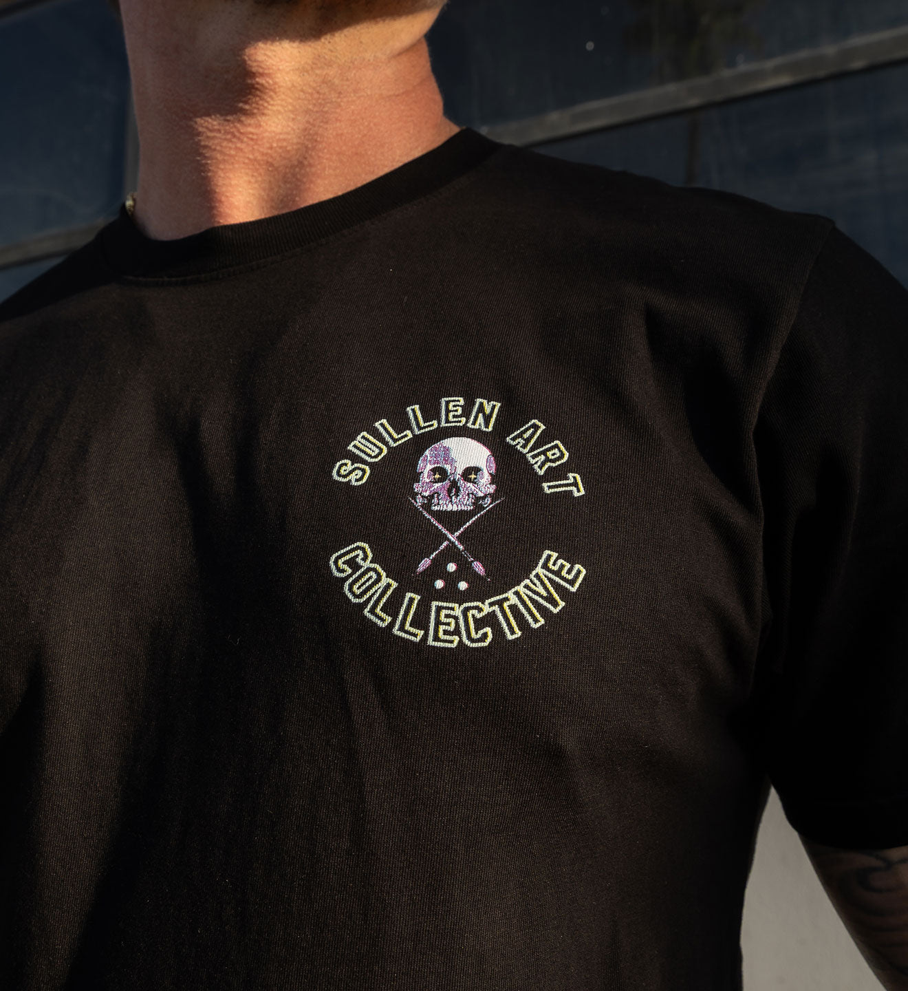 Black shirt with 'Sullen Art Collective' logo on the front