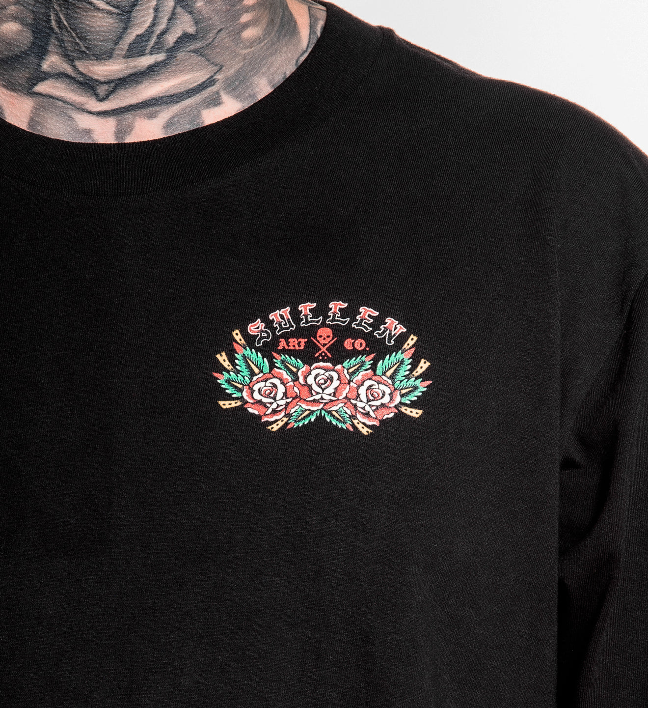 Black sweatshirt with embroidered design on chest, featuring text and floral elements.
