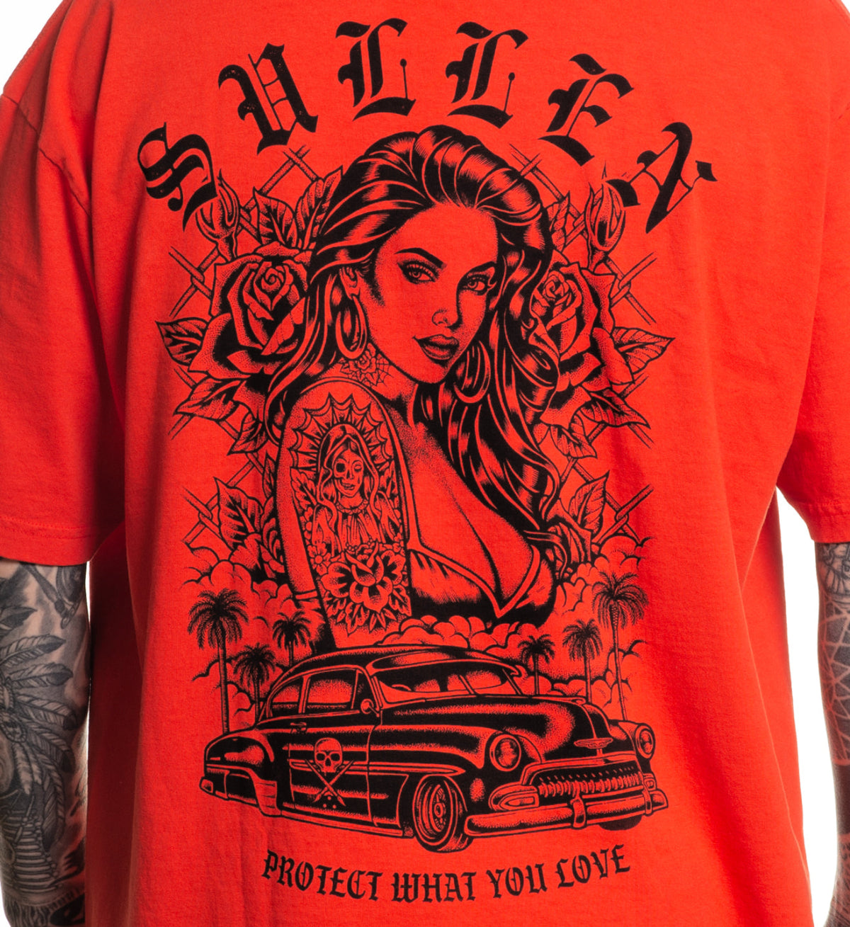 Red t-shirt with black graphic design of a woman, car, and text on a red background