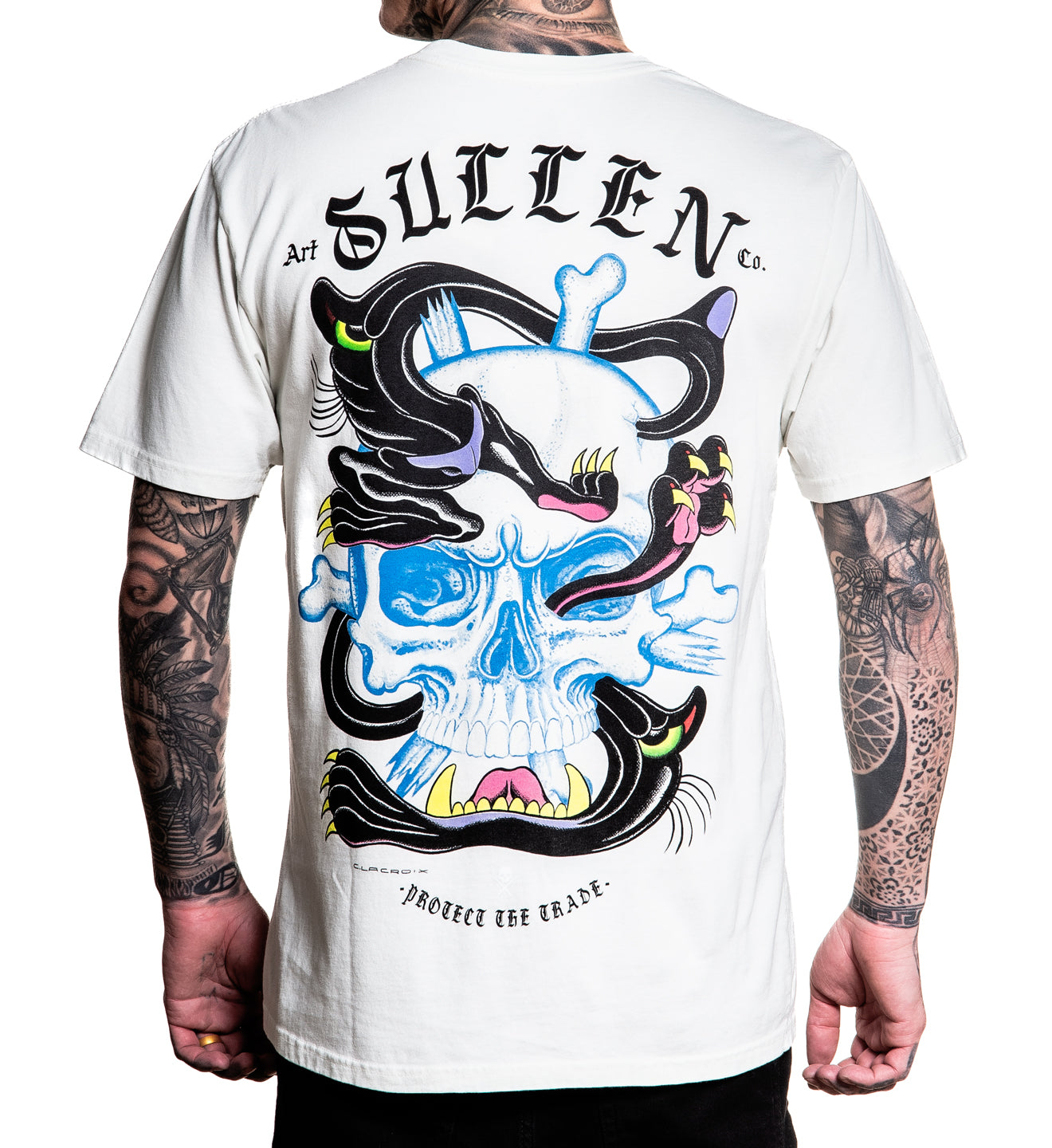 Person wearing a white t-shirt with a colorful skull design and 'Sullen' branding on the back.