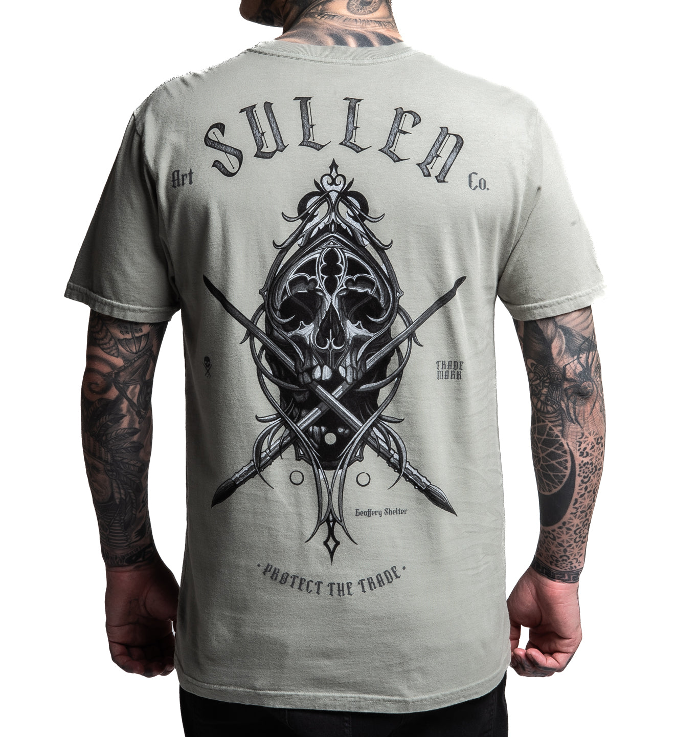 Person wearing a gray t-shirt with a black graphic design and 'Sullen' branding on the back.