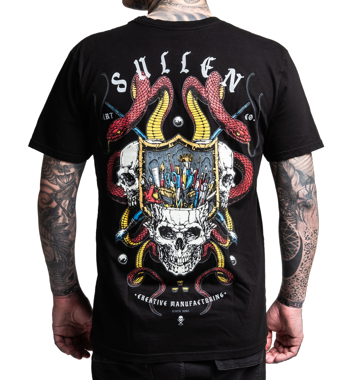 Black t-shirt with a detailed graphic design featuring skulls and snakes, worn by a person.