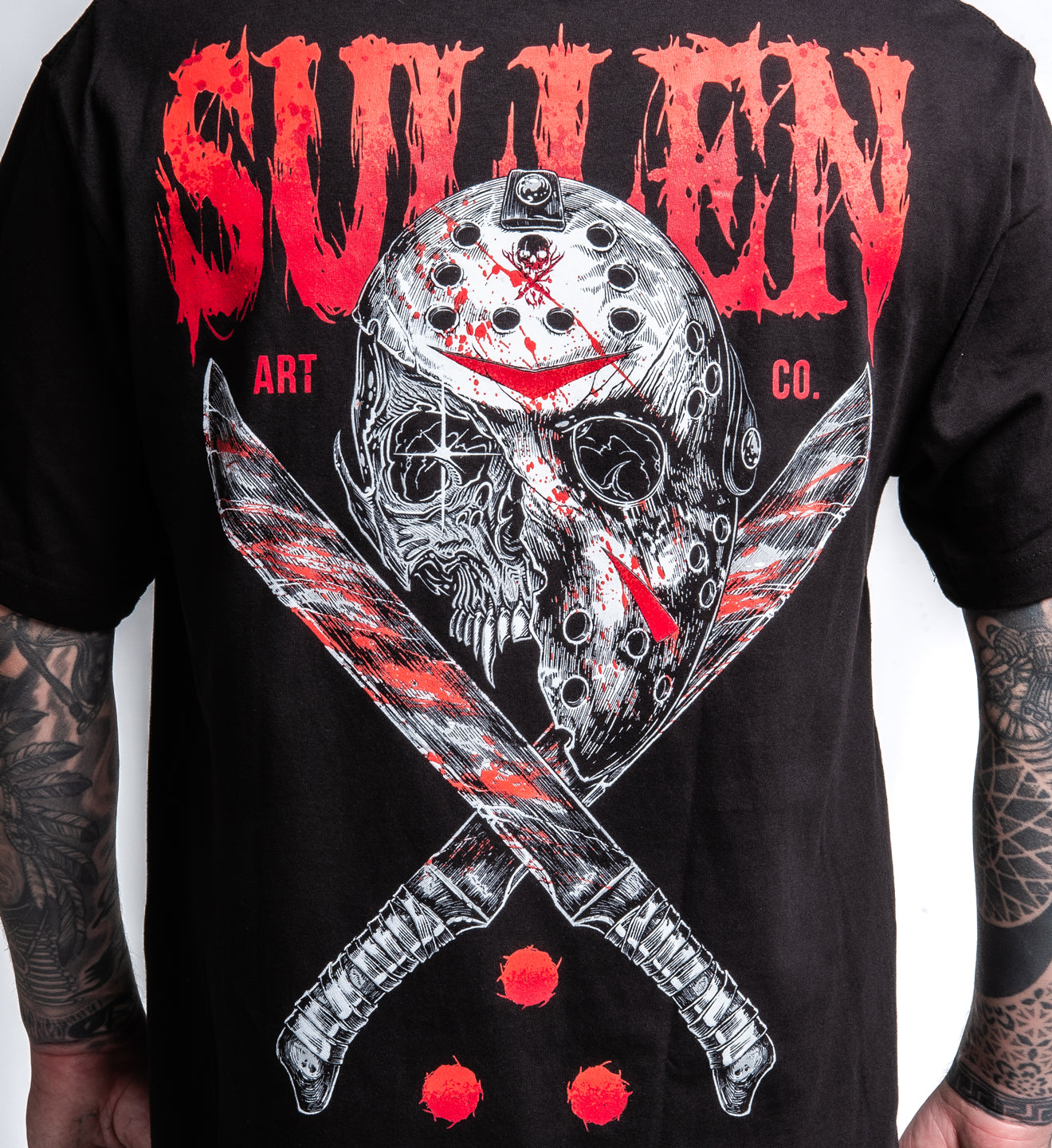 Black t-shirt with a graphic design of a mask and crossed swords, featuring the brand 'Sullen'.